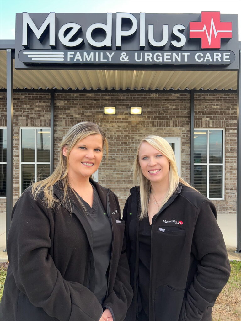 Two women standing in front of a building